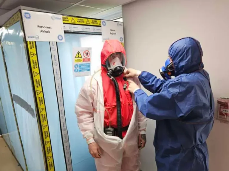 How Should Loose Lead Particles Be Removed From Protective Clothing